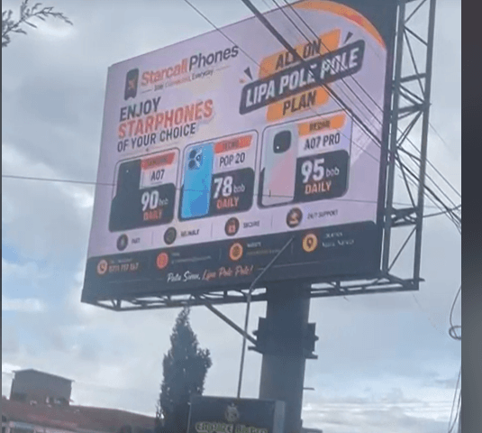 A StarCall Phones billboard showing specific daily payment plans for different phone models.